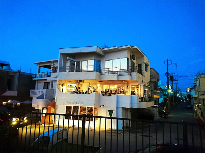 A trendy café by the beach. Go up the orange stairs on the side of the building.
