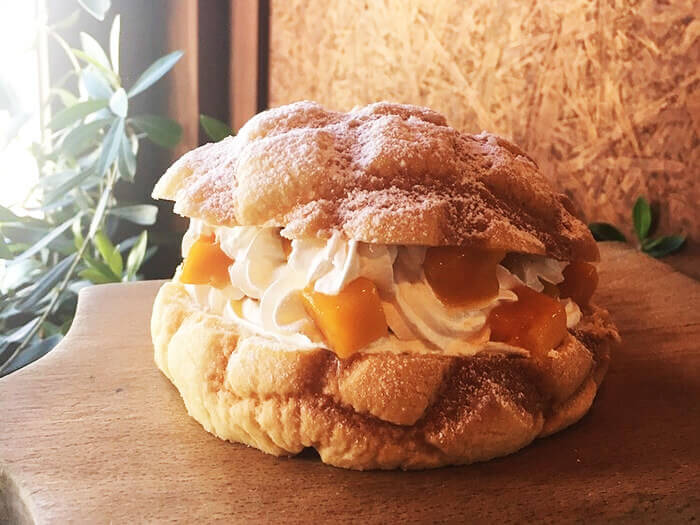 Mango-filled melon pan. It's got real mango in it. You can choose whipped cream or ice cream to go with it.